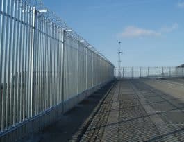 Robust palisade security fencing protecting an industrial site