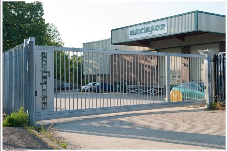 Non-Tracked Sliding Gate, with branding, at an Industrial Facility