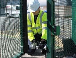 Technician carrying out force testing to electric gate