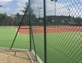 Chain link fence and posts around tennis courts